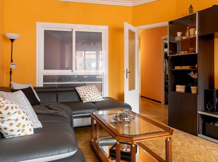 Salón con sofá de cuero y mueble de diseño